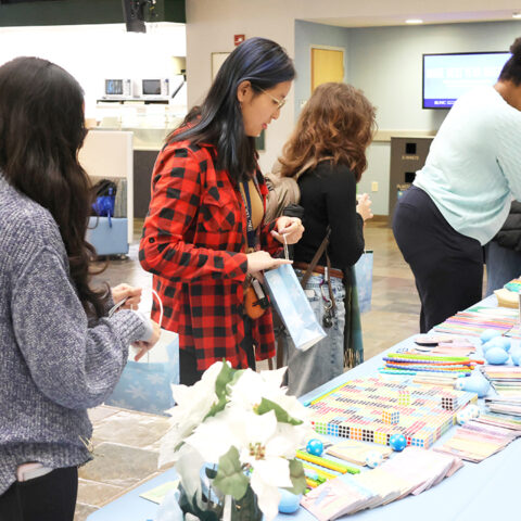 Photos of UNC students at the 2025 December Treat Yo Self event in the Carolina Union in the West Lounge Area.