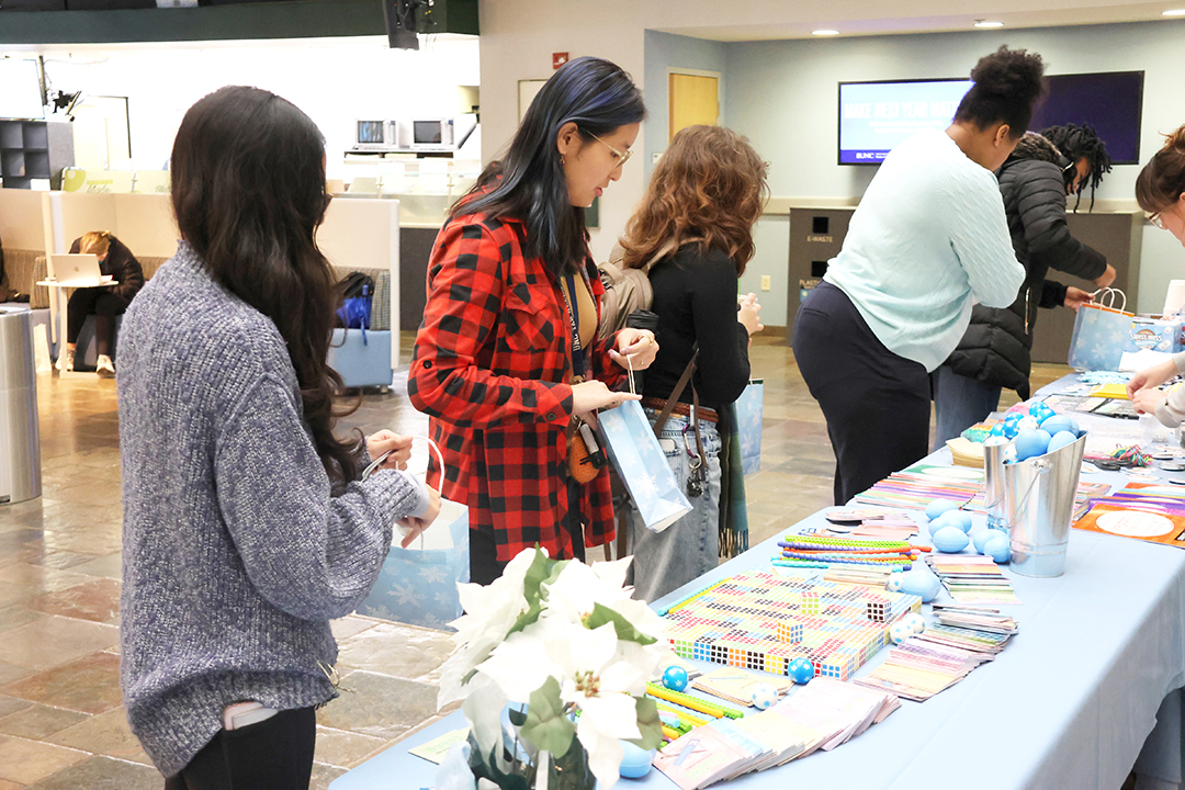 Photos of UNC students at the 2025 December Treat Yo Self event in the Carolina Union in the West Lounge Area.