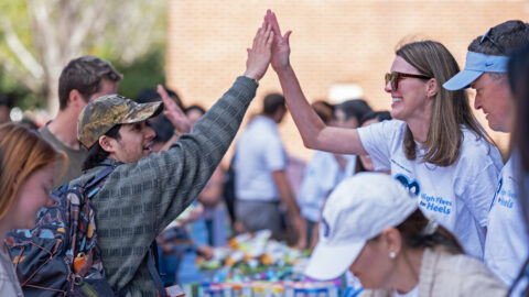 Two people high-fiving on the UNC-Chapel Hill campus