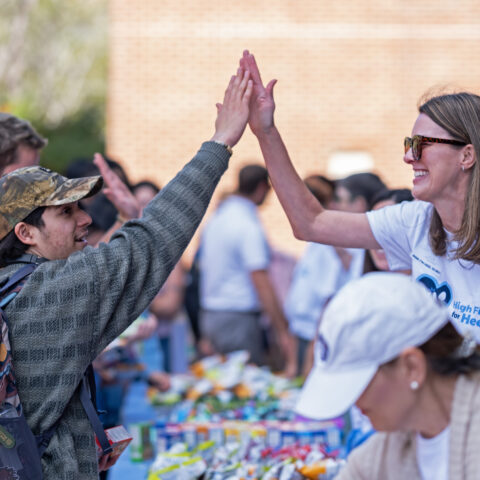 Two people high-fiving on the UNC-Chapel Hill campus