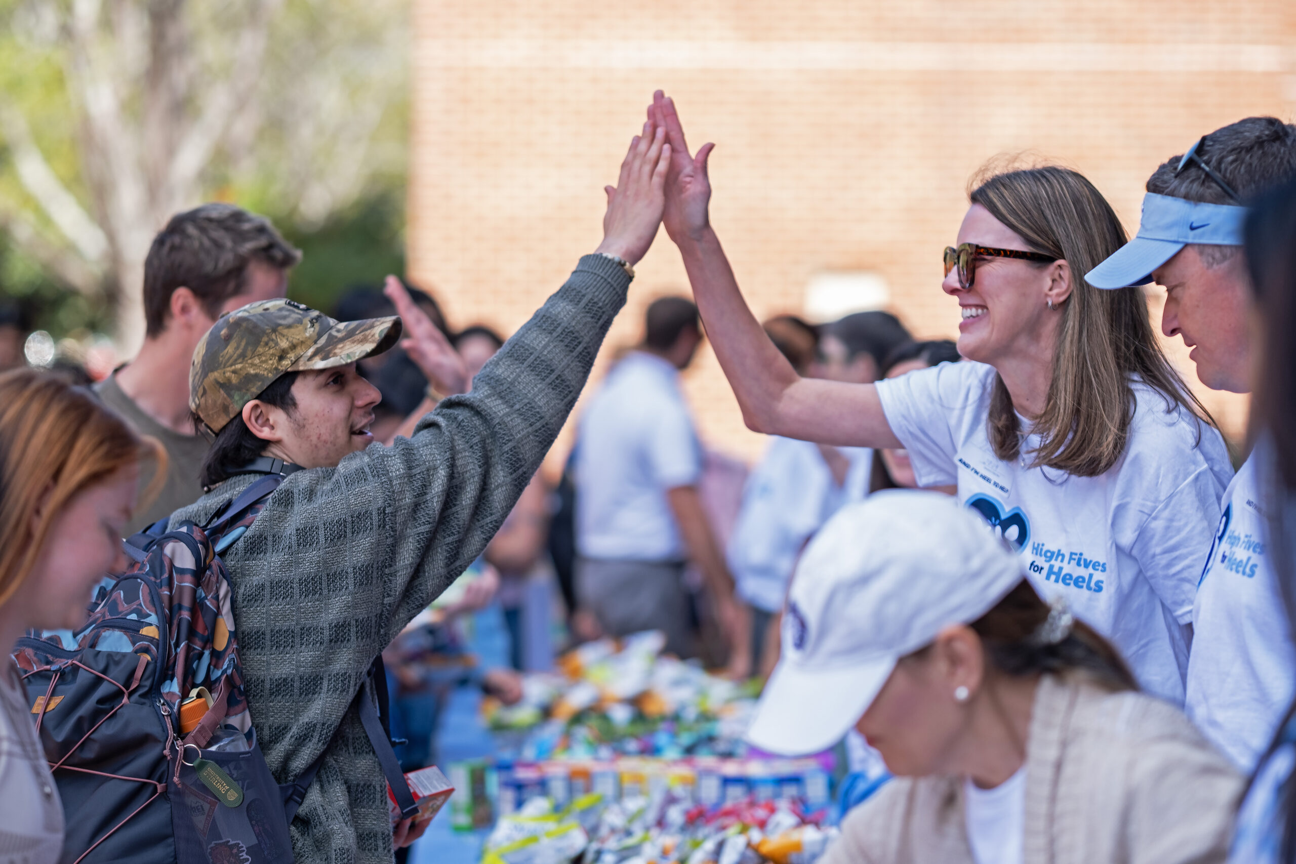 Two people high-fiving on the UNC-Chapel Hill campus