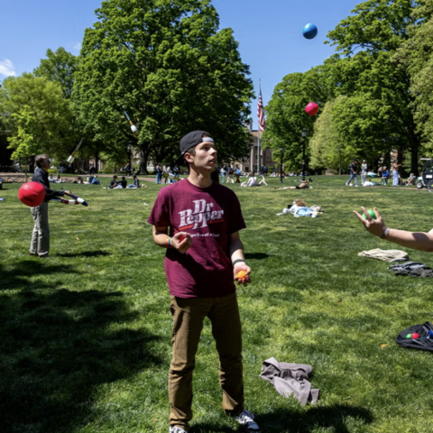 Students juggling on the quad of a University