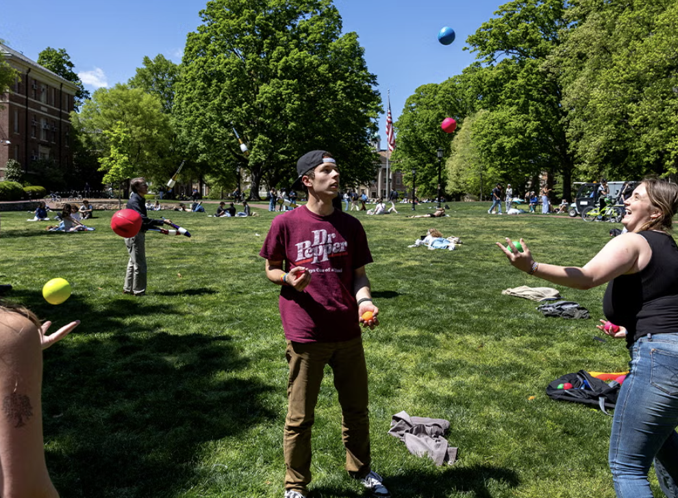Students juggling on the quad of a University
