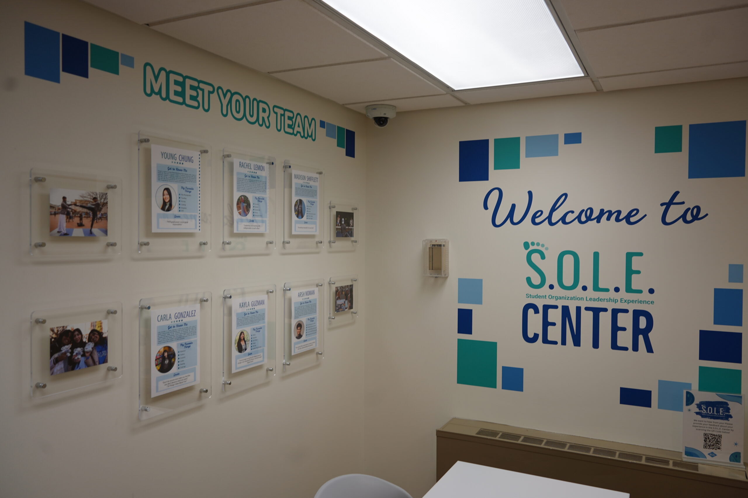 The entrance wall features the text "Welcome to S.O.L.E. Center," decorated with blue and green geometric shapes. 